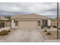 Single-story home with stone accents and a two-car garage at 19726 W Morning Glory St, Buckeye, AZ 85326