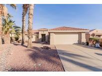 Charming single-story home with a red tile roof, desert landscaping and a spacious two-car garage at 22801 N Las Vegas Dr, Sun City West, AZ 85375