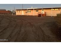 A single-story house with a tan exterior, multiple windows and doors, and a simple staircase at 29967 N Sandridge Dr, Queen Creek, AZ 85144