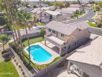 Backyard aerial view of a beautiful home with a sparkling blue pool and palm trees at 3591 S Larkspur Way, Chandler, AZ 85248