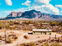 Charming exterior of a desert home featuring scenic mountain views and a natural desert landscape at 4129 E Roundup E St, Apache Junction, AZ 85119