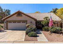 Charming single-story home featuring a tile roof, lush landscaping, and a two-car garage at 5373 W Dublin Ct, Chandler, AZ 85226