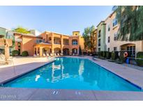 Resort-style pool with lounge chairs and well-maintained landscaping in a beautiful community setting at 14575 W Mountain View Blvd # 11222, Surprise, AZ 85374