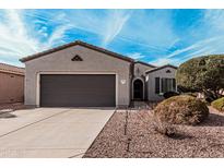 Charming single-story home with a two-car garage, well-maintained landscaping, and inviting curb appeal at 17061 W Peregrine Ln, Surprise, AZ 85387