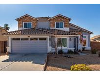 Charming two-story home featuring a stone accent exterior and a spacious two-car garage at 1937 W Burgess Ln, Phoenix, AZ 85041