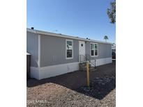 Gray single-wide manufactured home with a small yard at 320 E Mckellips Rd # 50, Mesa, AZ 85201