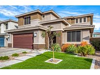 Beautiful two-story home featuring a well-manicured front yard with lawn and desert landscaping at 3320 E Tina Dr, Phoenix, AZ 85050