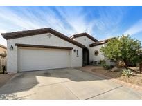 A charming home featuring a well-manicured lawn, a two-car garage, and an inviting front entrance at 4439 E Ficus Way, Gilbert, AZ 85298