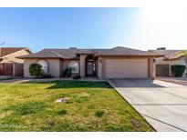 Charming home featuring a well-manicured lawn and a two-car garage at 4507 E Towne Ln, Gilbert, AZ 85234