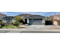 One-story home with gray exterior, landscaped yard, and two-car garage at 5840 S Pico St, Gilbert, AZ 85298