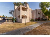 Two-story condo building with a walkway and landscaping at 7510 E Thomas Rd # 234, Scottsdale, AZ 85251