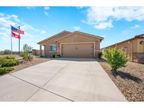 Single-story home with two-car garage and desert landscaping at 961 W 20 Th St, Florence, AZ 85132