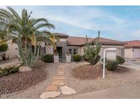 Single-story home with desert landscaping and a stone walkway at 16019 W Kino Dr, Surprise, AZ 85374