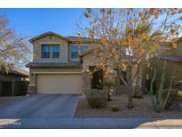 Two story home featuring a desert landscape, and a two car garage at 17965 W Carol Ave, Waddell, AZ 85355