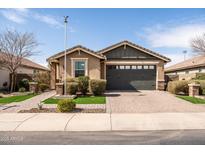 Charming single-story home featuring a well-manicured front yard and a two-car garage at 18716 N Jameson Dr, Maricopa, AZ 85138