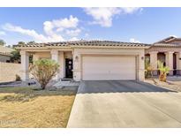 Charming single-story home featuring a tile roof, desert landscaping, and a two-car garage at 2865 E Cathy Dr, Gilbert, AZ 85296