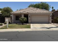 Charming single-story home with a well-manicured lawn and a two-car garage at 2865 E Cathy Dr, Gilbert, AZ 85296