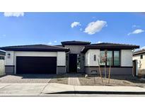 Single-story home with a two-car garage and landscaped front yard at 39190 N Kaden Ln, San Tan Valley, AZ 85140