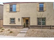 Charming front exterior featuring tan stucco and coordinated trim, gravel landscaping at 3937 S 79Th Ln, Phoenix, AZ 85043