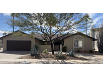 Inviting single-story home featuring desert landscaping, a two car garage and neutral color palette at 4535 E Marconi Ave, Phoenix, AZ 85032