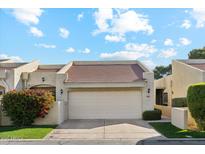 Attractive front exterior of home with a two-car garage and landscaping at 7359 E Valley View Rd, Scottsdale, AZ 85250