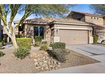 Single-story home with a two-car garage and landscaped front yard at 8862 W Cameron Dr, Peoria, AZ 85345