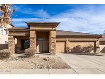 Single-story home with stone accents and a two-car garage at 13756 W Watson Ln, Surprise, AZ 85379