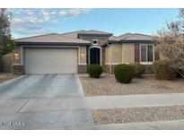 Charming single-story home features a two-car garage and well-maintained landscaping at 15704 W Taylor St, Goodyear, AZ 85338