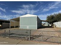 Mobile home with carport and fenced yard at 16634 N Queen Esther Dr, Surprise, AZ 85378