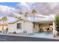 Single-level manufactured home with carport and desert landscaping at 1841 E Augusta Ave, Chandler, AZ 85249