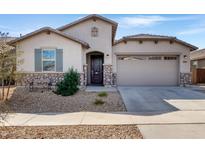 Charming single-Gathering home featuring stone accents, desert landscaping, and a two-car garage at 18819 W Cholla St, Surprise, AZ 85388