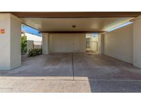 Covered carport with concrete flooring and access to the unit at 2571 N Miller Rd, Scottsdale, AZ 85257