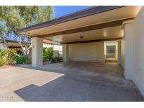 Covered carport with concrete flooring and access to the unit at 2571 N Miller Rd, Scottsdale, AZ 85257