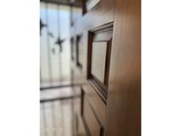 Close up on paneled front door with stars hanging on the front porch at 2571 N Miller Rd, Scottsdale, AZ 85257