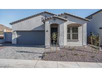 Single-story home with gray exterior, two-car garage, and landscaped front yard at 2811 N 212Th Dr, Buckeye, AZ 85396