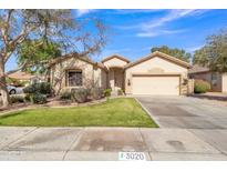 Single-story house with a two-car garage and well-manicured lawn at 3020 E Lark Dr, Chandler, AZ 85286