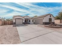 Charming single-Gathering home featuring a three-car garage, well-maintained landscaping, and a welcoming facade at 17347 W Statler St, Surprise, AZ 85388