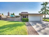 Ranch style home with attached garage and well-manicured lawn at 17449 N 106Th Ave, Sun City, AZ 85373