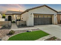 Single-story home with a two-car garage and landscaped front yard at 28107 N 123Rd Ln, Peoria, AZ 85383