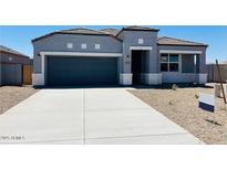 Charming single-story home with gray exterior, well-maintained landscaping, and a two-car garage at 28242 N Nealite Dr, San Tan Valley, AZ 85143