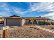 Single-story home with a two-car garage and desert landscaping at 3125 W Waltann Ln, Phoenix, AZ 85053