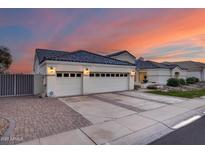 White stucco house with a three-car garage and landscaped front yard at 5635 W Melinda Ln, Glendale, AZ 85308