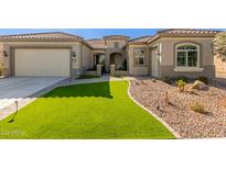 Single-story home with a two-car garage and landscaped front yard at 7815 W Cinder Brook Way, Florence, AZ 85132