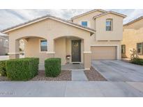 Inviting two-story home with neutral tones, landscaped front, covered entry, and attached two car garage at 8535 E Olla Ave, Mesa, AZ 85212