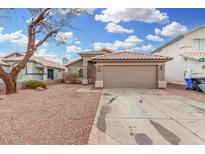 Single-story home with a brown garage door and a gravel driveway at 8732 W Granada Rd, Phoenix, AZ 85037