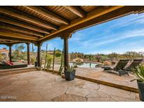 Backyard oasis with a pool, comfortable lounge chairs, desert landscaping and stunning views at 10712 E Prospect Point Dr, Scottsdale, AZ 85262