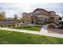 Tan two-story home with landscaping and walkway at 14870 W Encanto Blvd # 1014, Goodyear, AZ 85395