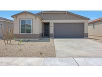 Single-story home with a two-car garage and desert landscaping at 18100 W Sand Hills Dr, Surprise, AZ 85387