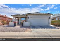 Charming single-story home features a well-maintained front yard, a two-car garage and tiled roof at 1885 E Sycamore E Rd, Casa Grande, AZ 85122