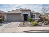 One-story home with gray exterior, stone accents, and landscaped front yard at 21370 N 260Th Ln, Buckeye, AZ 85396